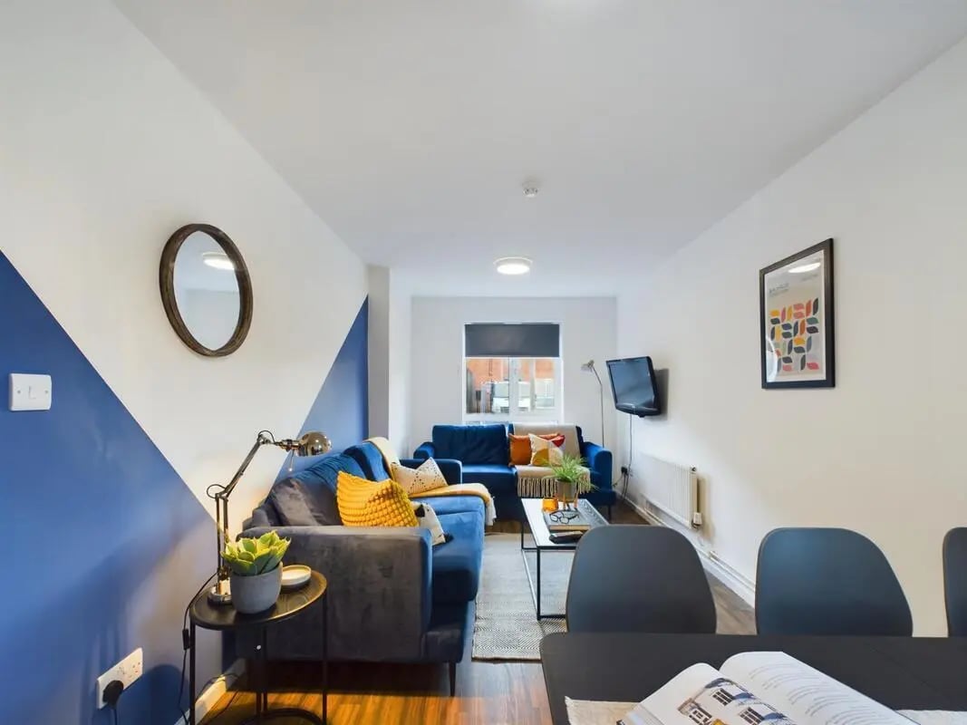 Blue couches coffee table artwork living room at 3 Bedroom House at 5, Brookside in Derby Student Accommodation