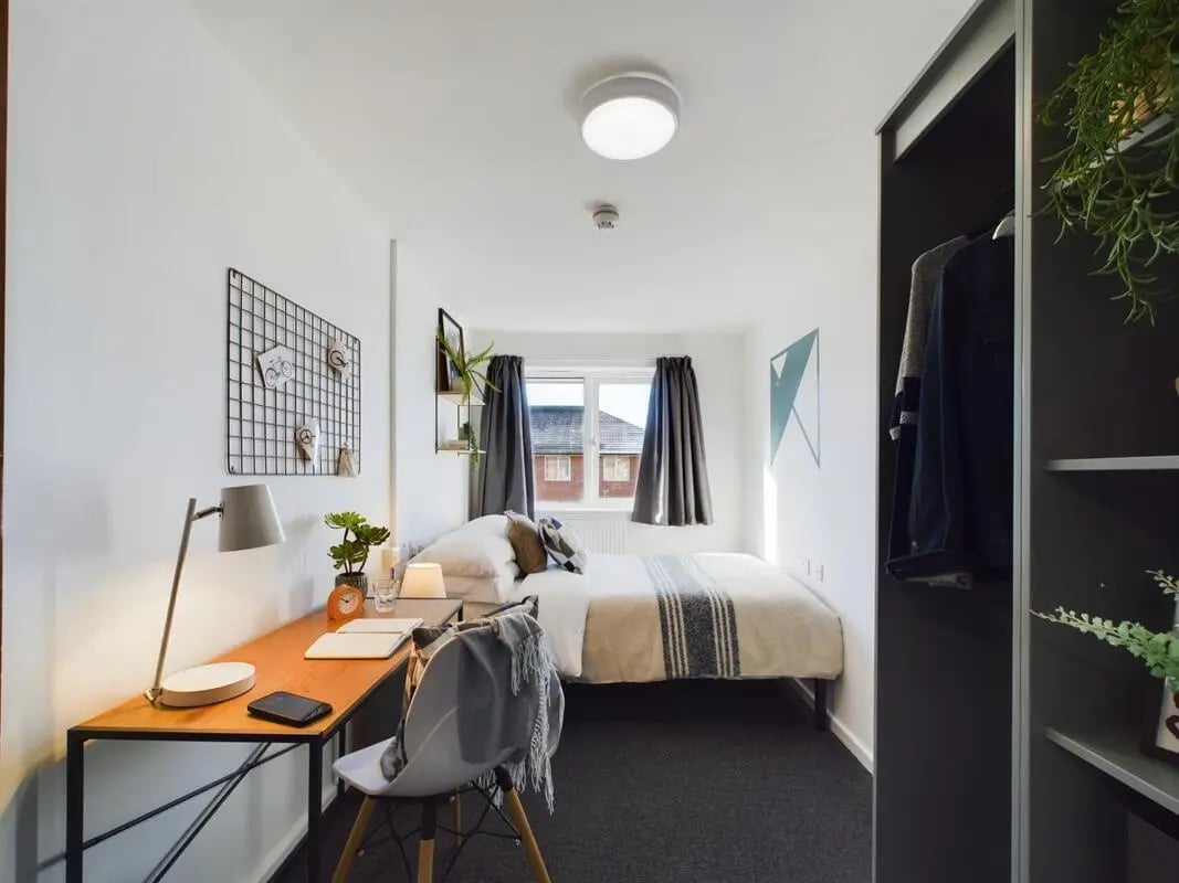Desk bed closet plants and chair bedroom at 3 Bedroom House at 6, Brookside in Derby Student Accommodation