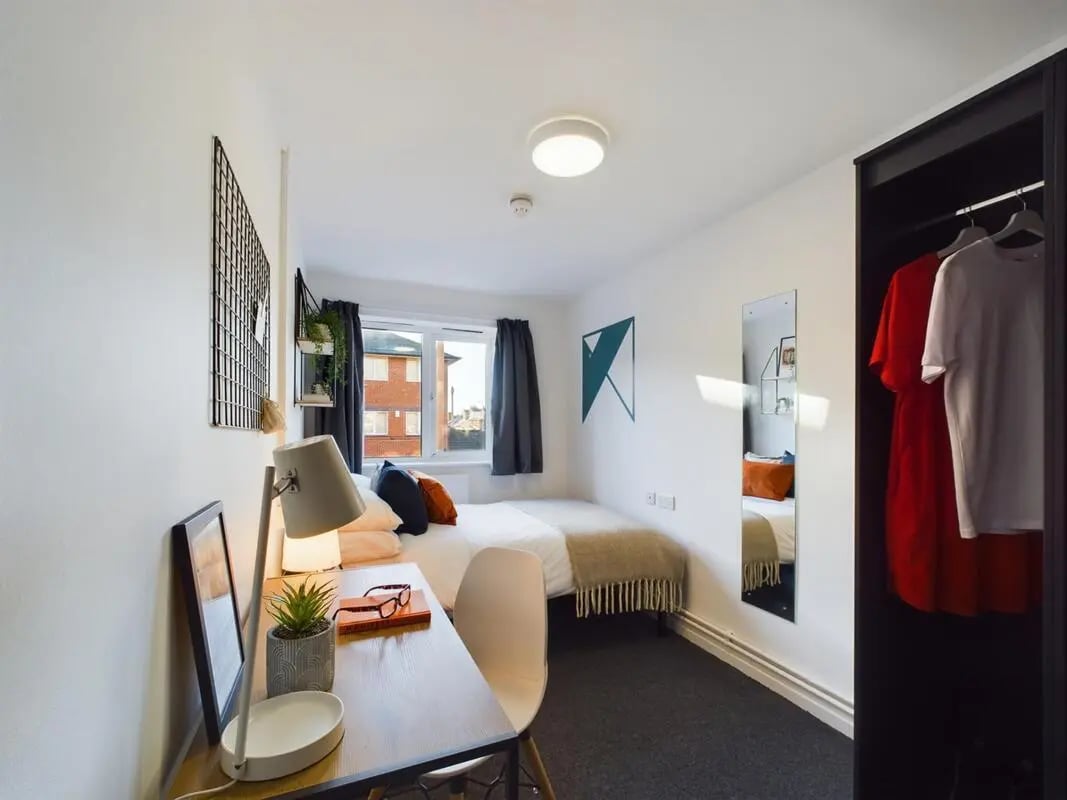 Desk lamp bed wardrobe with clothes bedroom at 6 Bedroom House at 24, Brookside in Derby Student Accommodation