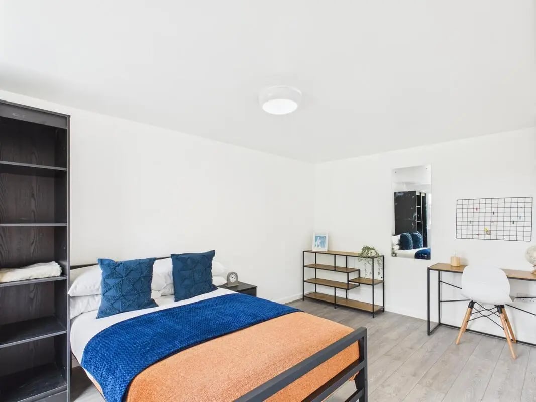 Bed with blue pillows desk with chair bedroom at 1 Bedroom House at Flat 15, Grove Street Studios, The Groves in Liverpool Student Accommodation
