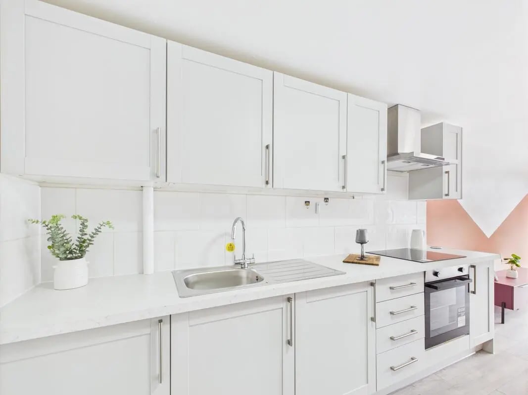 White kitchen cabinets sink stove oven kitchen at 1 Bedroom House at Flat 19, Grove Street Studios, The Groves in Liverpool Student Accommodation