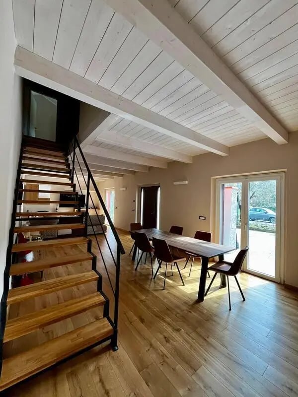 Wooden staircase dining table chairs living room at Welcoming double ensuite bedroom near the Vezzano Ligure train station in La Spezia Student Accommodation