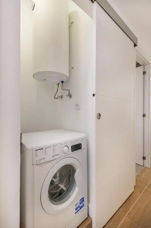 Washing machine and water heater laundry area at Luxurious 1-bedroom apartment in Vilamoura in Faro Student Accommodation