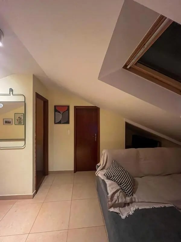 Sofa artwork mirror door living room at Beachfront Loft in Viana Do Castelo Student Accommodation