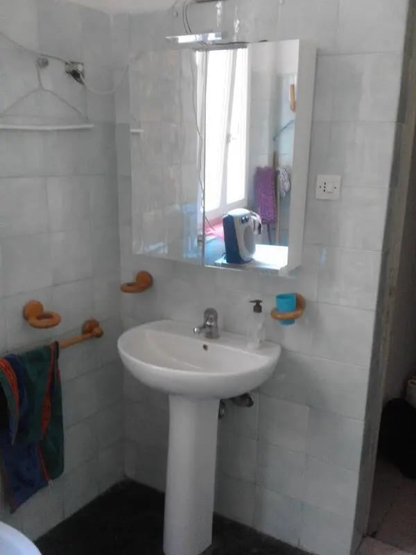 Sink mirror and towel rack bathroom at Single Bedroom in a 4 bedroom apartment in Parma in Parma Student Accommodation