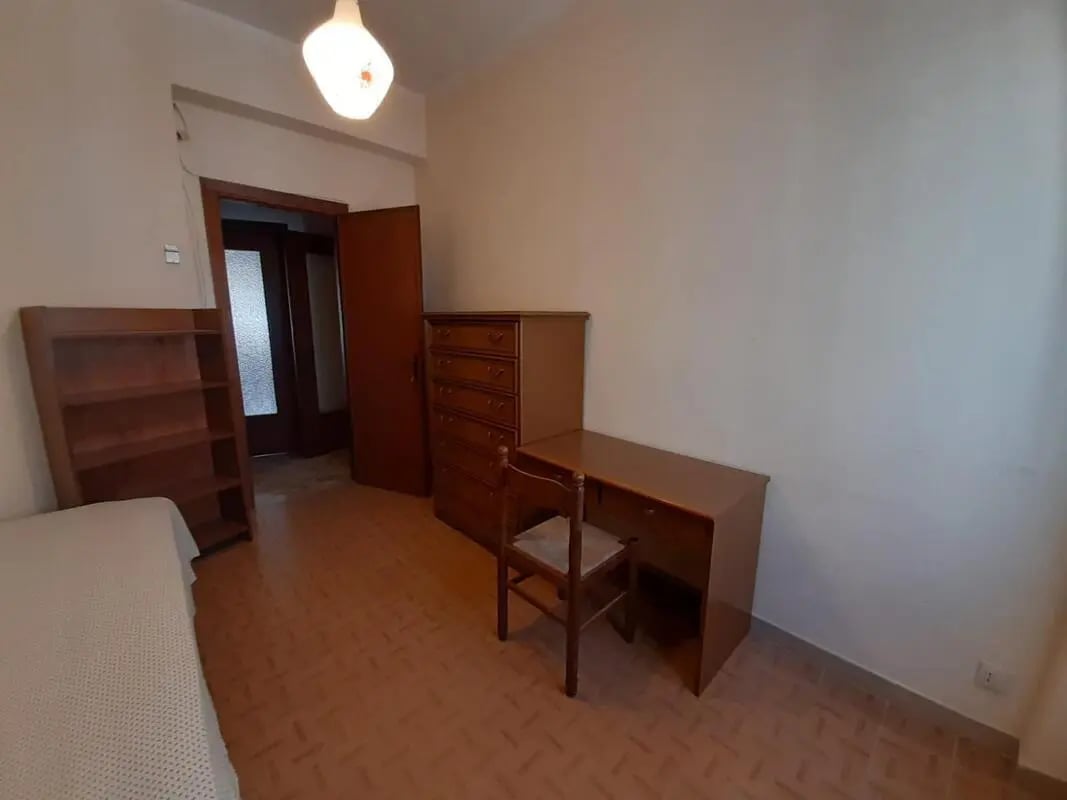 Bed desk dresser bookshelf study area at Single bedroom close to Università degli Studi Mediterranea di Reggio Calabria in Reggio Calabria Student Accommodation