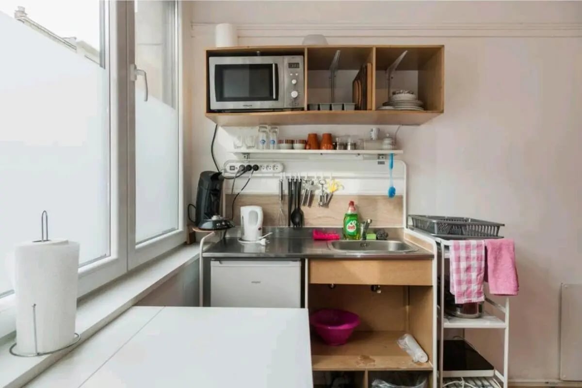 Microwave kettle coffee maker sink compact kitchen at Very cosy studio in Berchem in Antwerp Student Accommodation