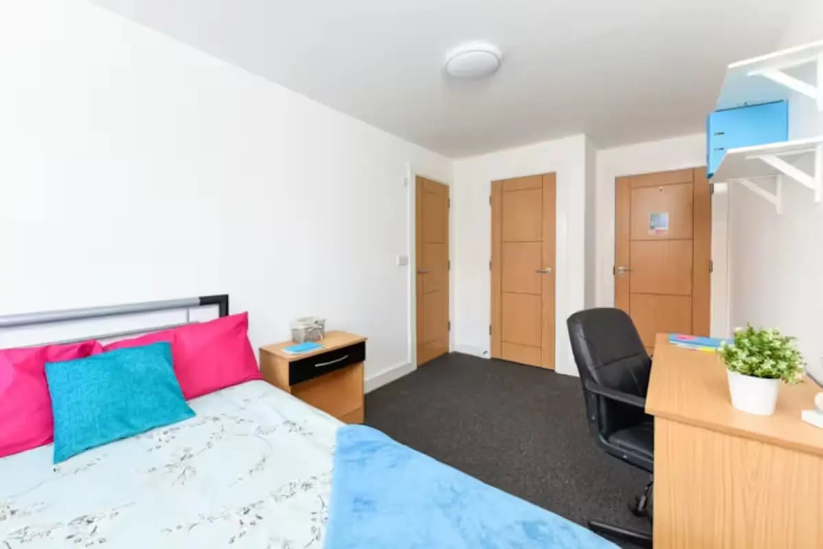 Bed desk chair and doors student bedroom at Brookland Road in Leicester Student Accommodation