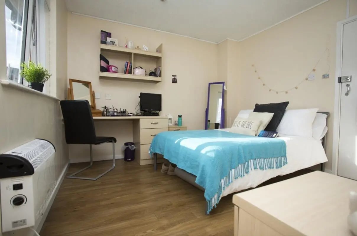 Desk bed heater mirror and shelving bedroom at Manchester Court in Manchester Student Accommodation