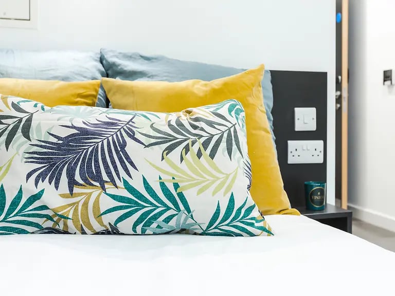 Pillows on bed with floral pattern Bedroom at Canterbury Student Manor in Canterbury Student Accommodation