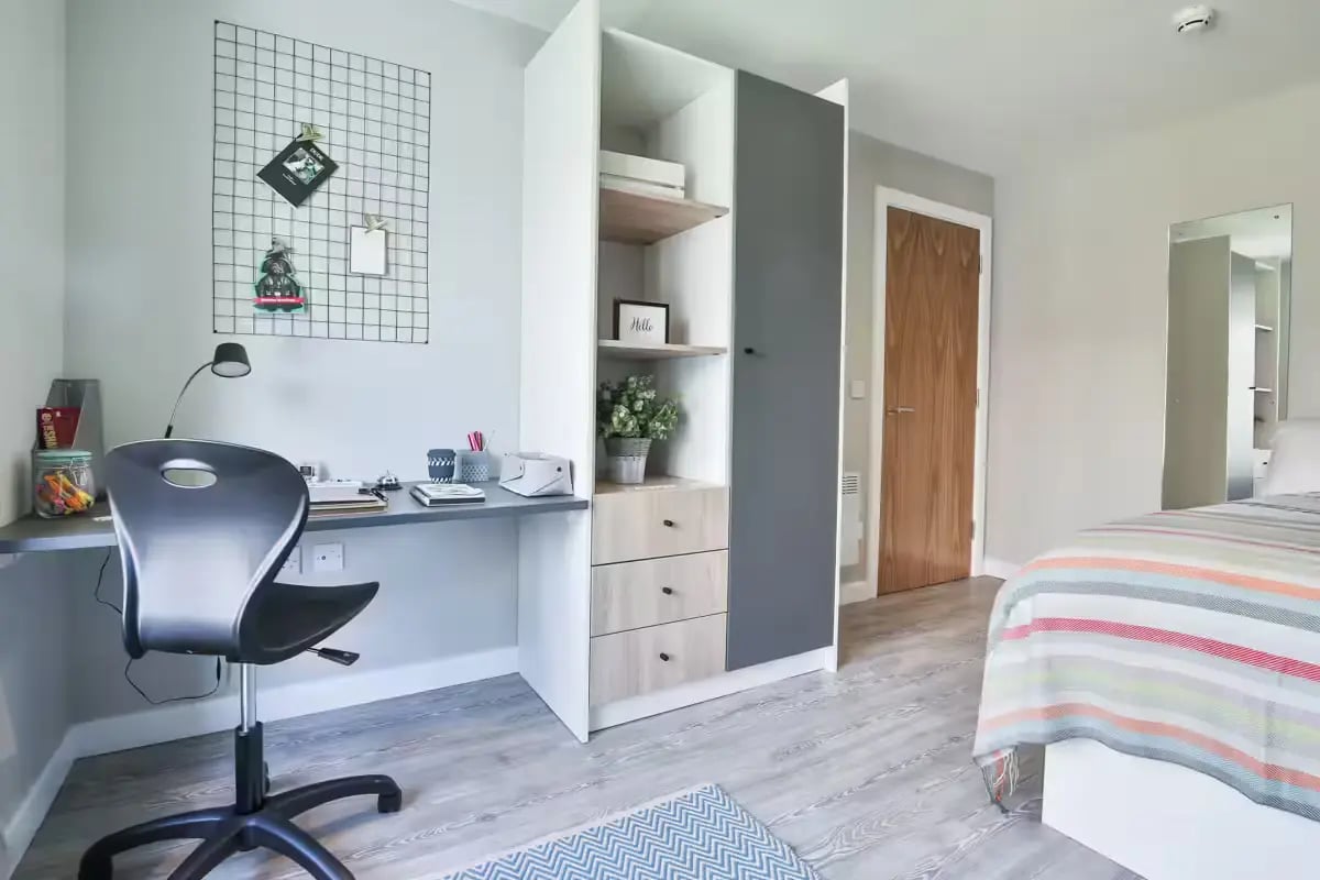 Desk chair wardrobe with shelves and drawers bedroom at Victoria Point in Manchester Student Accommodation