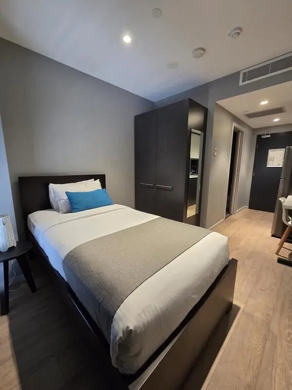 Bed wardrobe and door bedroom at Sydney Student Living Top Ryde in Sydney Student Accommodation
