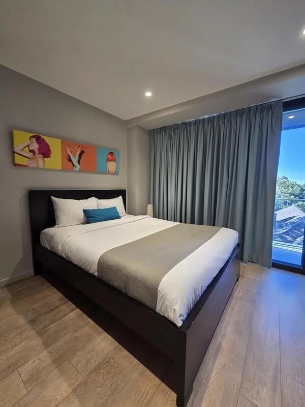 Modern bedroom with art and large window bedroom at Sydney Student Living Top Ryde in Sydney Student Accommodation