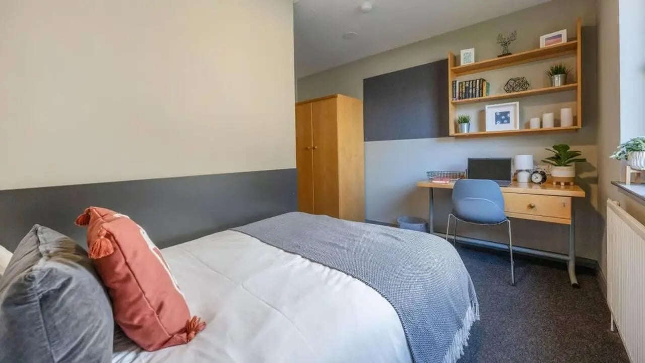 Bed desk wardrobe and shelving study area at Clarence Dock Village in Leeds Student Accommodation