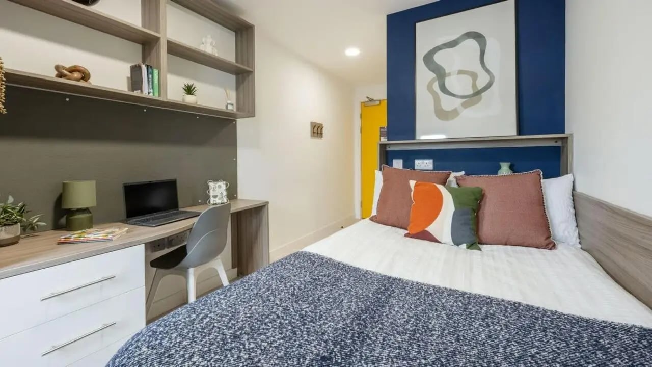 Desk bed shelves laptop and chair bedroom at Foundry Courtyard in Glasgow Student Accommodation