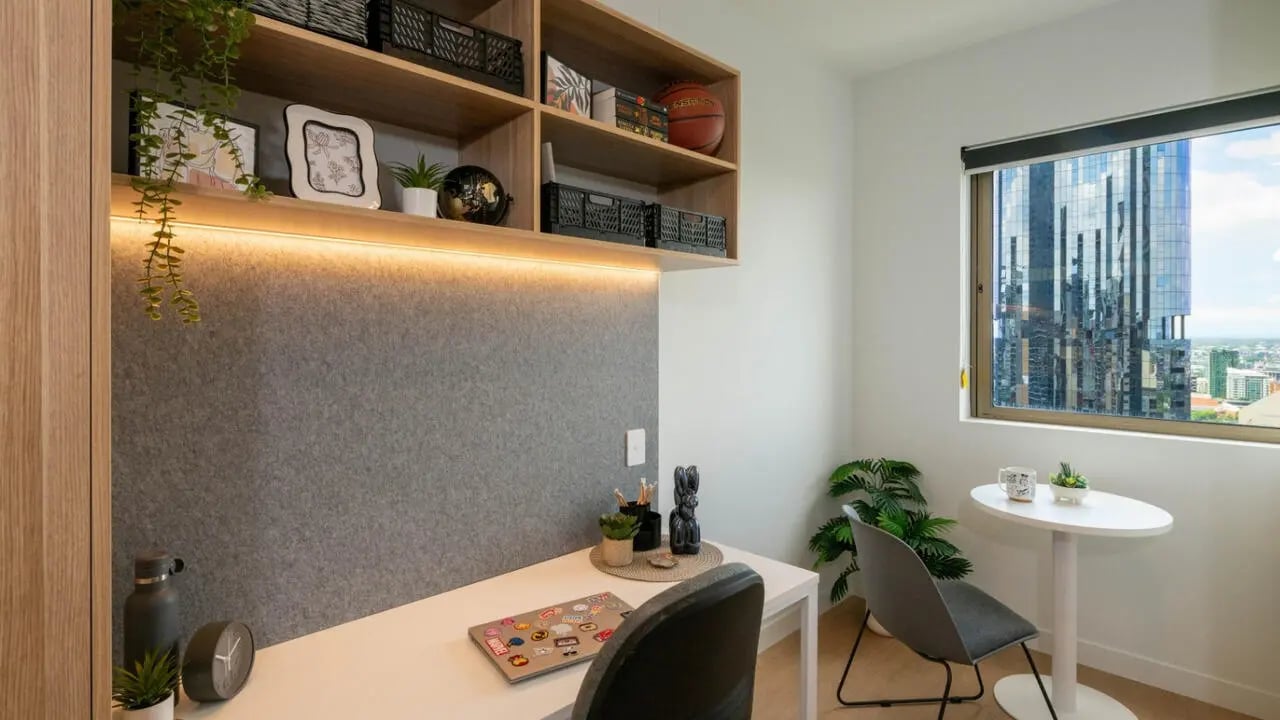 Desk with laptop and shelving study area at UniLodge Brisbane City in Charleston Student Accommodation