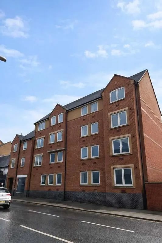 Brick student accommodation building with multiple windows exterior at Mintworks in Leicester Student Accommodation