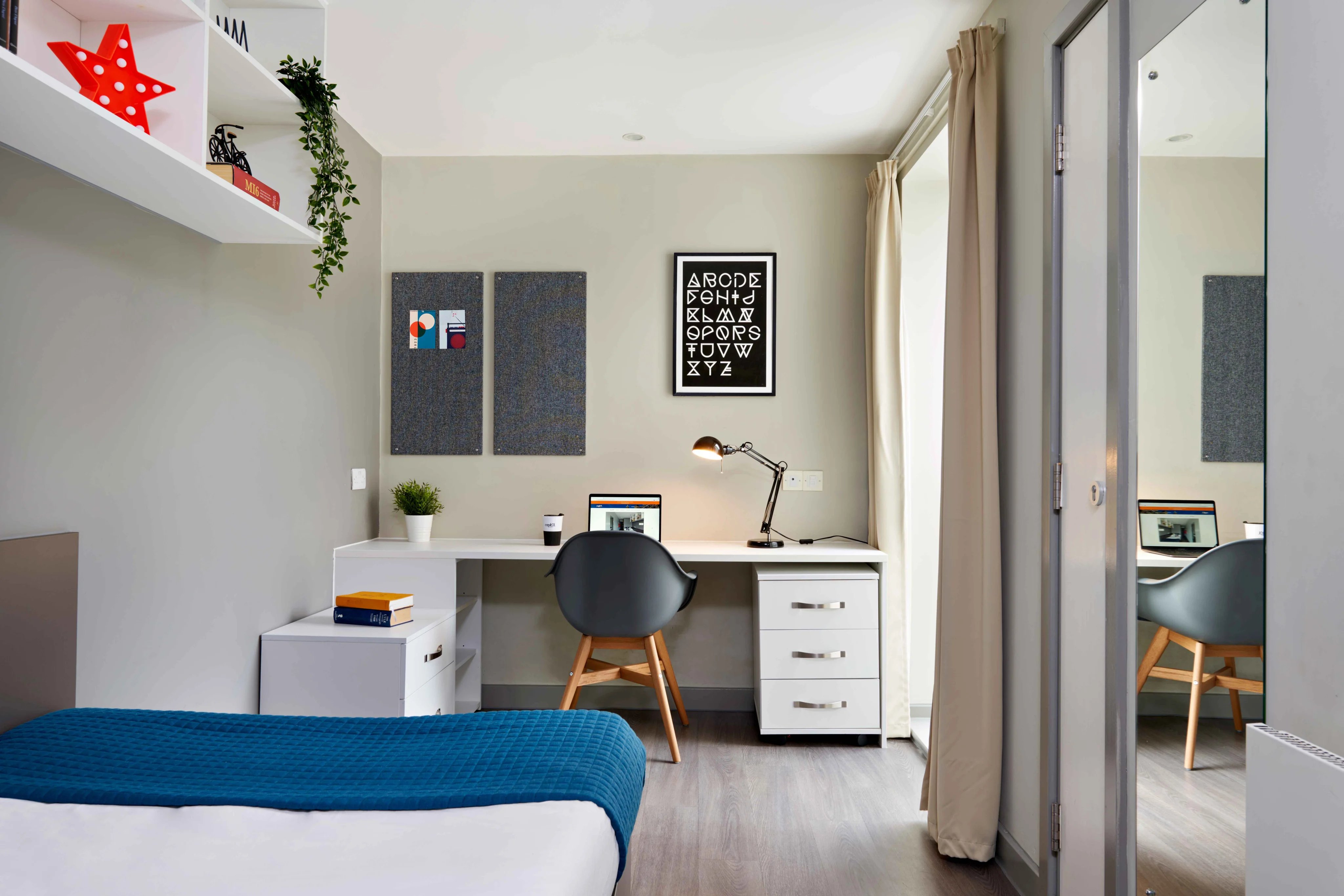 Bed desk lamp chair and shelves bedroom at Saw Mill in Huddersfield Student Accommodation