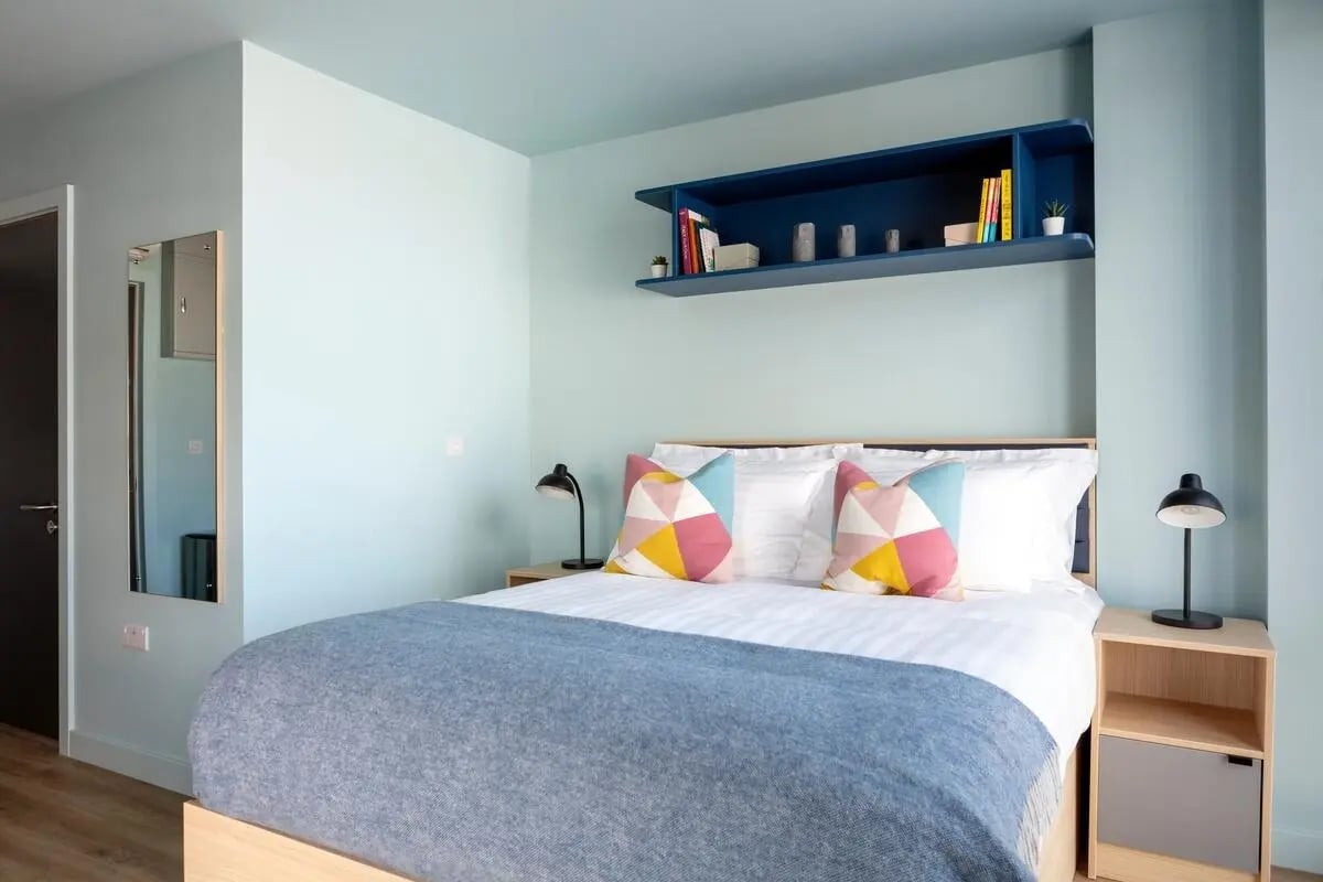 Bed pillows lamps and shelf bedroom at Coleman Court in Cork Student Accommodation