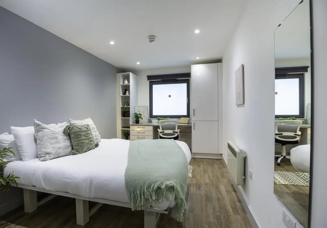 Bed desk wardrobe mirror bedroom at The Bridge Phase II in Newcastle Upon Tyne Student Accommodation