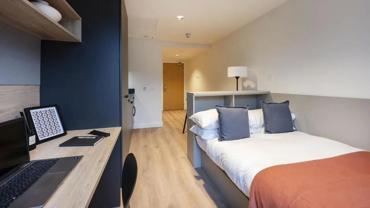 Desk laptop framed picture bed with pillows bedroom at Straits Place in Edinburgh Student Accommodation