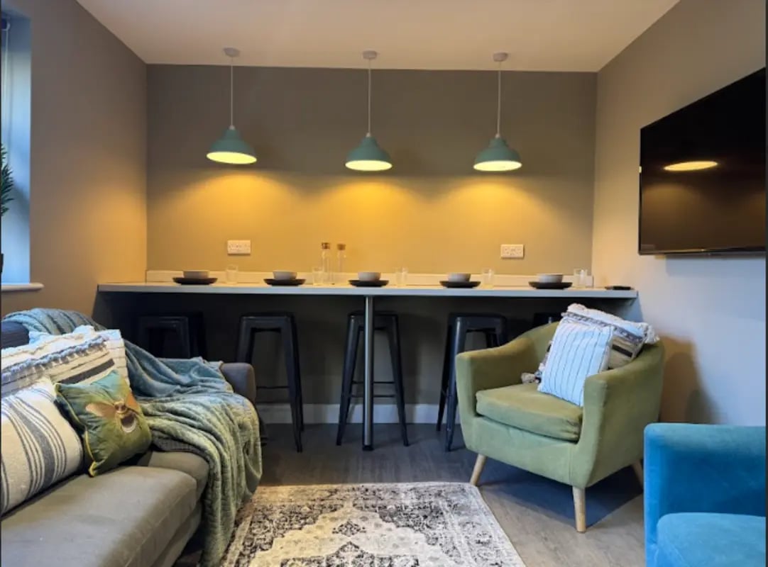Sofa bar stools chairs and rug living room at Varsity Beeston in Nottingham Student Accommodation