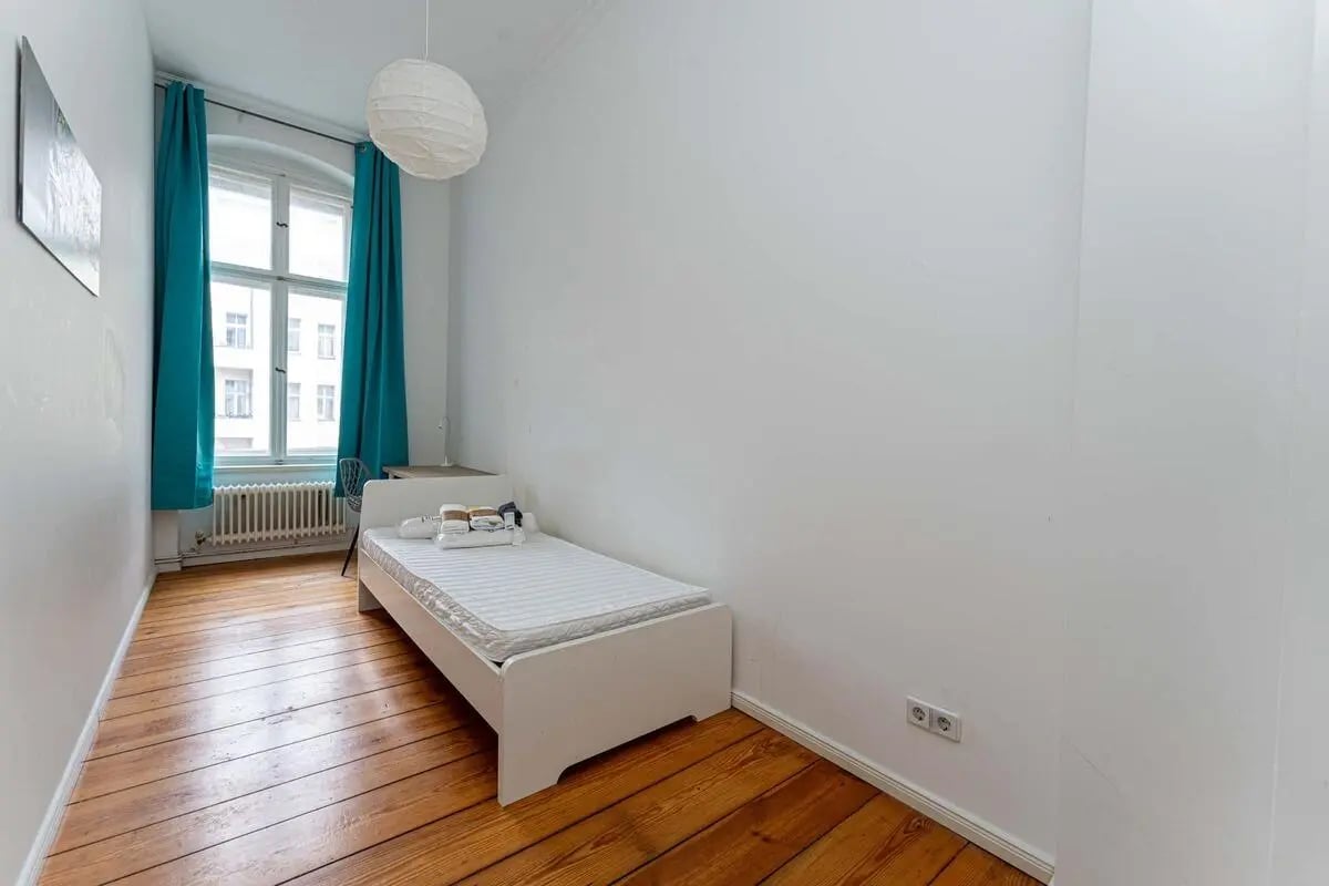 Bed desk lamp and window bedroom interior at Kaiser-Friedrich-Straße - Room 4 in Berlin Student Accommodation