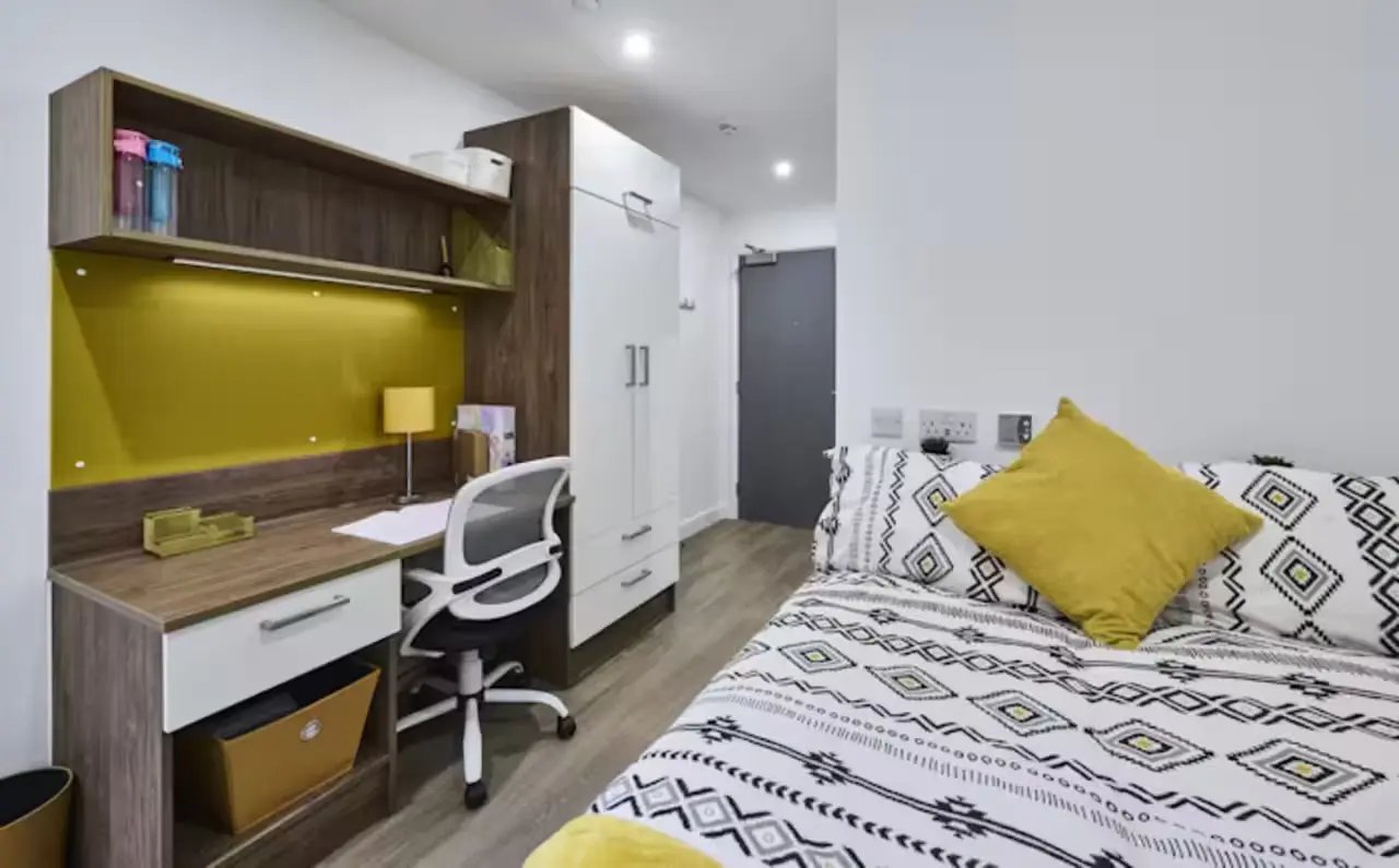 Desk chair bed wardrobe and shelves bedroom at The Oaks in Coventry Student Accommodation