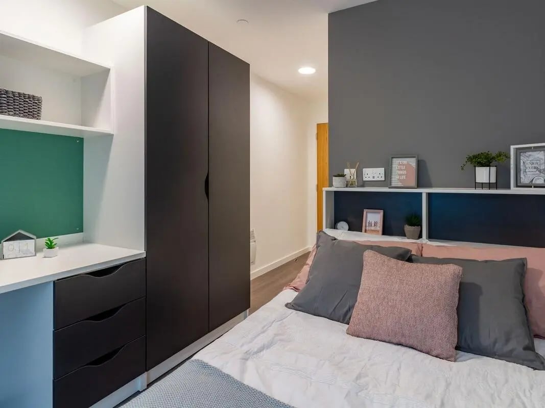 Wardrobe desk shelves with basket and drawers bedroom at Pavilion Court London in London Student Accommodation