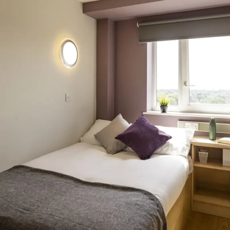 Bed with pillows bedside table and window bedroom at Belgrave View in Birmingham Student Accommodation