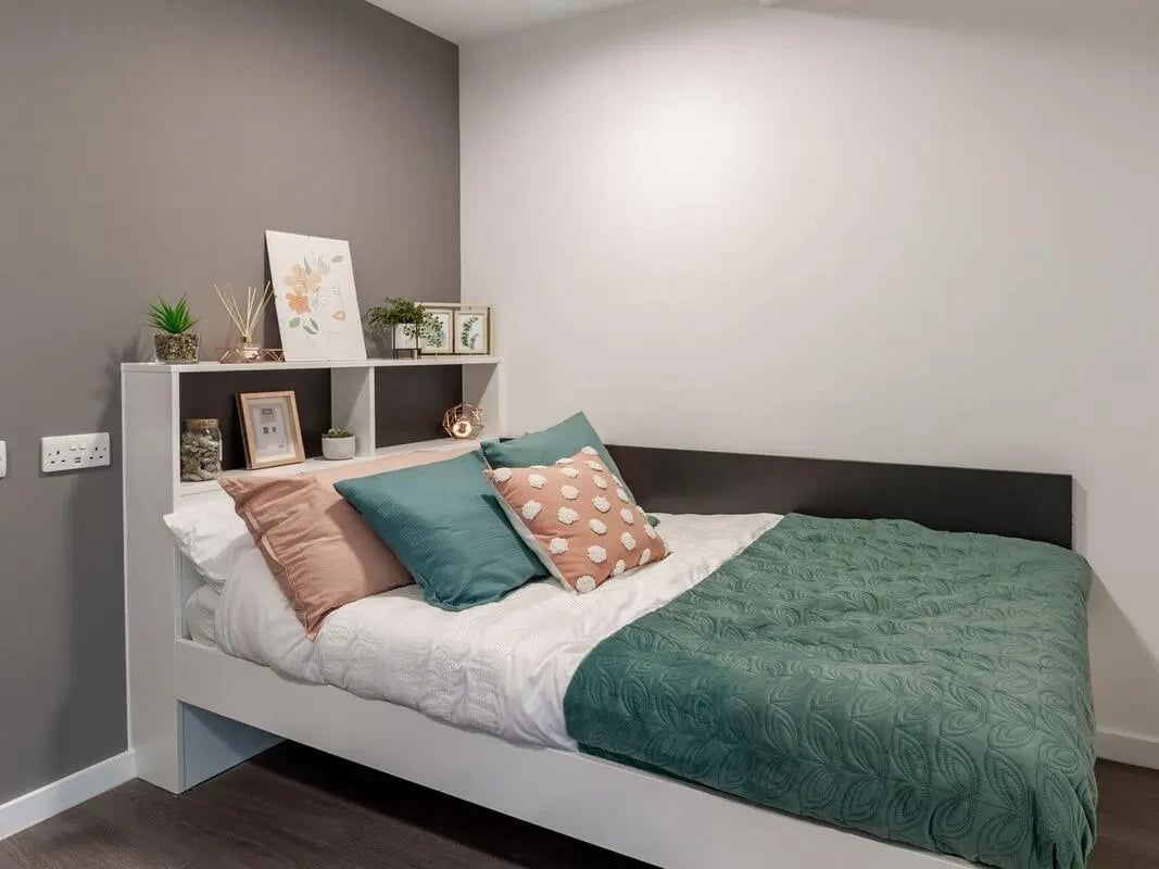 Bed with pillows shelf decor bedroom at Pavilion Court London in Wembley Student Accommodation
