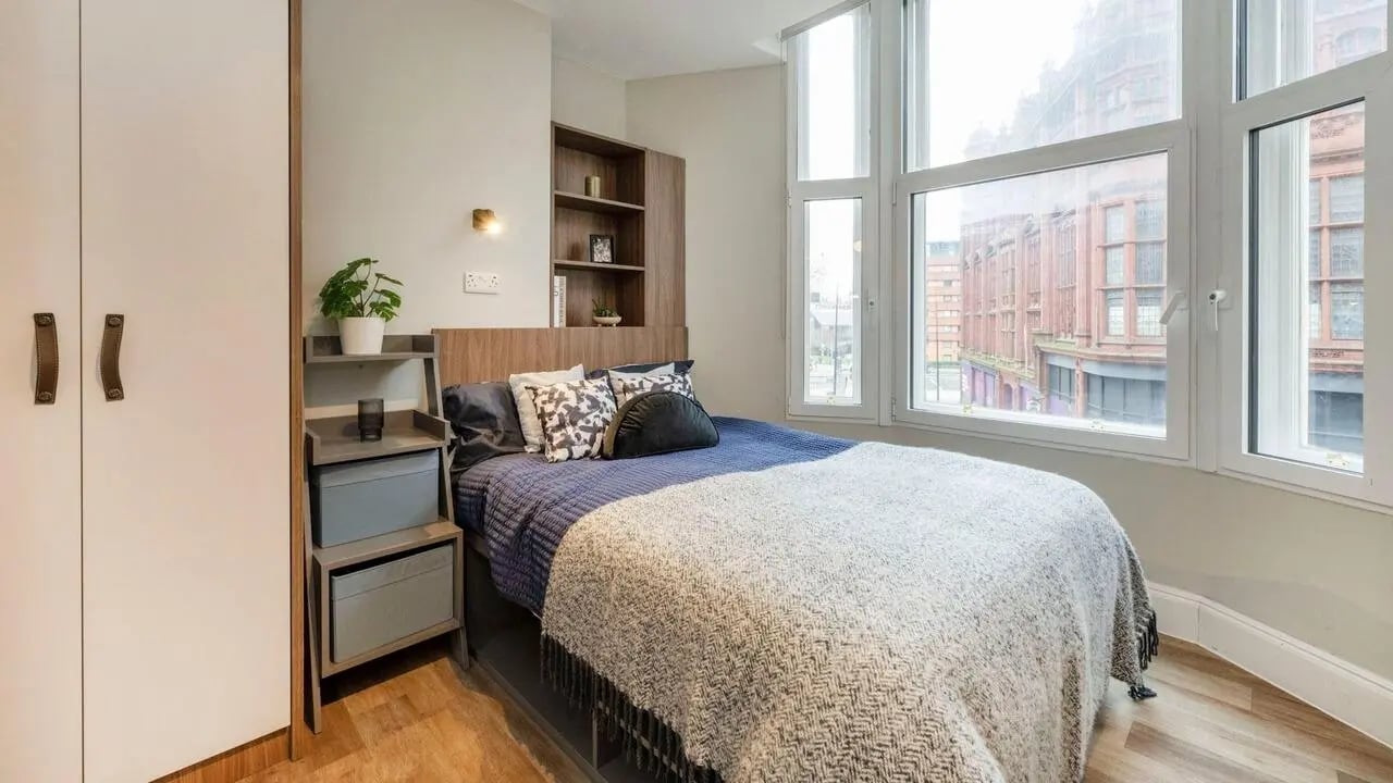 Bed with blankets bedside table and wardrobe bedroom at Chamberlain Place in Birmingham Student Accommodation