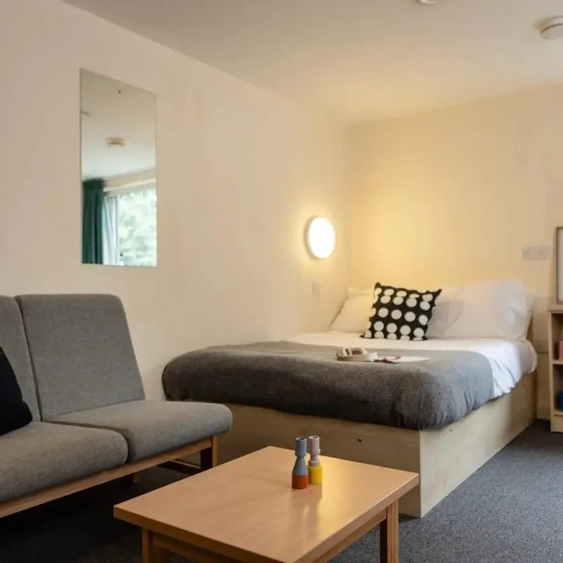 Bed sofa and table in student accommodation bedroom at Burley Road in Leeds Student Accommodation