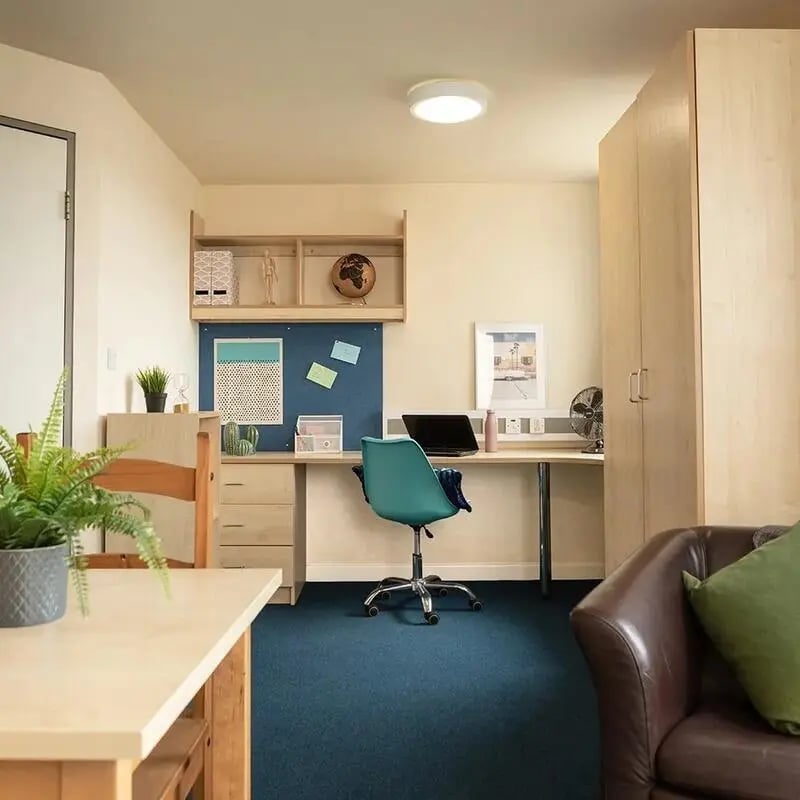 Desk chair laptop globe and wardrobe study area at Burley Road in Leeds Student Accommodation