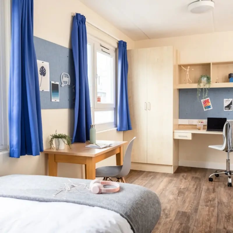 Bed desk wardrobe and chair bedroom at Mcmillan student Village in Greenwich Student Accommodation