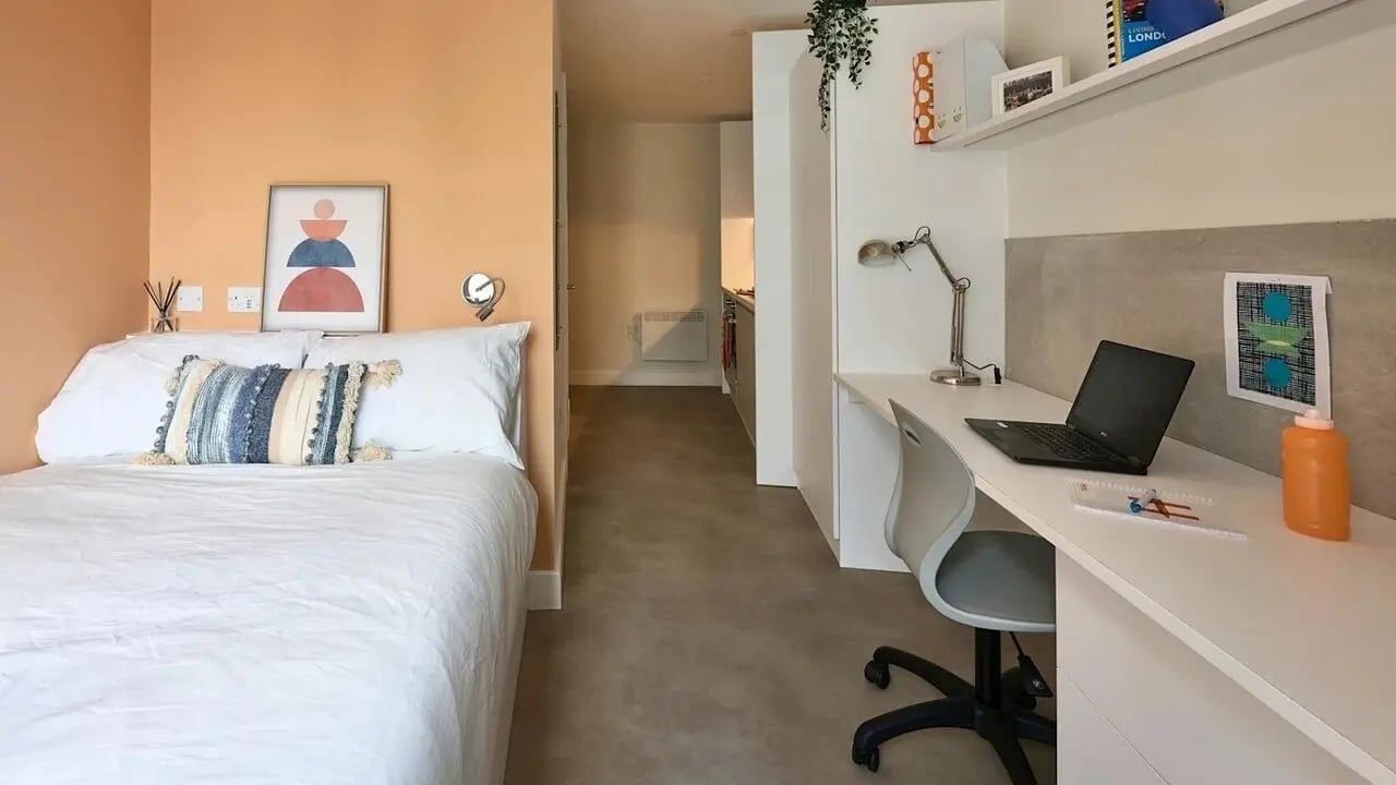 Bed desk laptop and chair study area at View Studios in London Student Accommodation