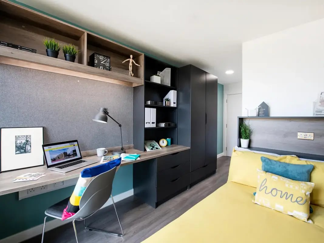 Desk laptop chair shelves wardrobe bed bedroom at Yugo Anglia House in Cambridge Student Accommodation