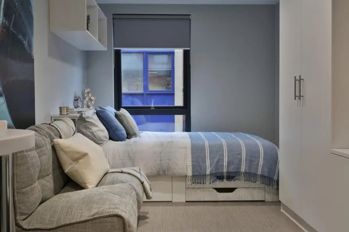 Bed, sofa, and wardrobe bedroom at Portobello House in Sheffield Student Accommodation