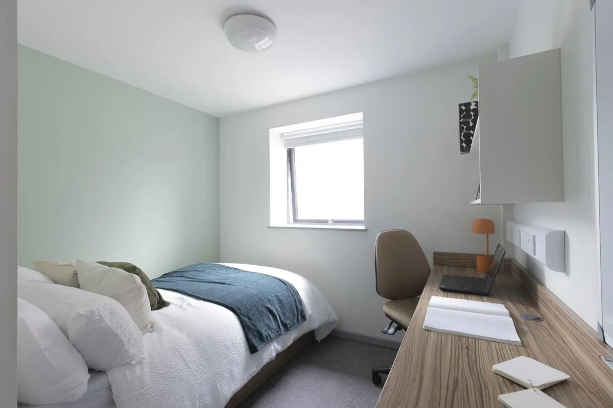 Bed desk chair laptop and notebook bedroom at Rosedale Court in Newcastle Upon Tyne Student Accommodation