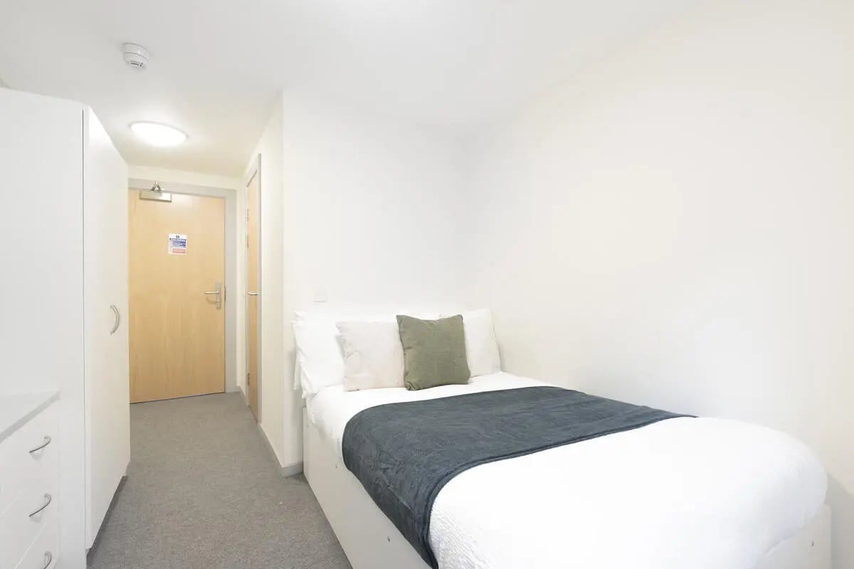 Bed white pillows dark blanket bedroom at Marshall Court in Newcastle Upon Tyne Student Accommodation