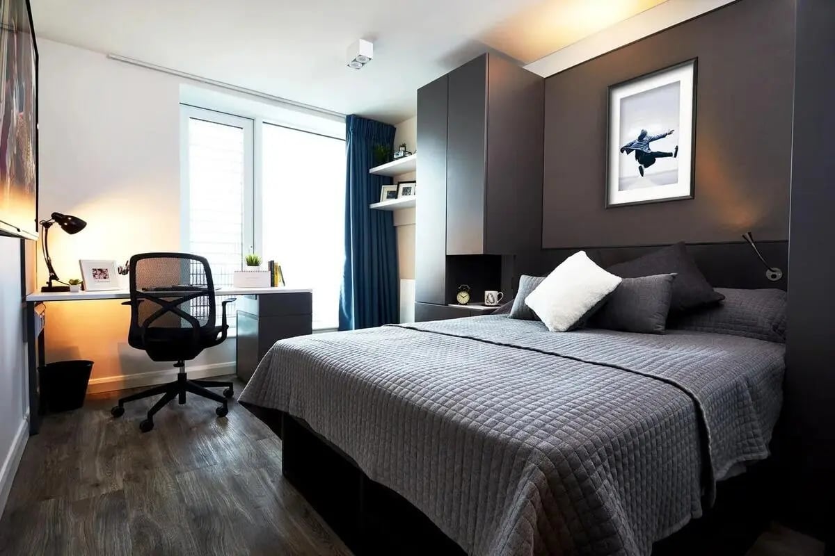 Bed desk chair and artwork bedroom interior at Vita Student Manchester Circle Square in Manchester Student Accommodation