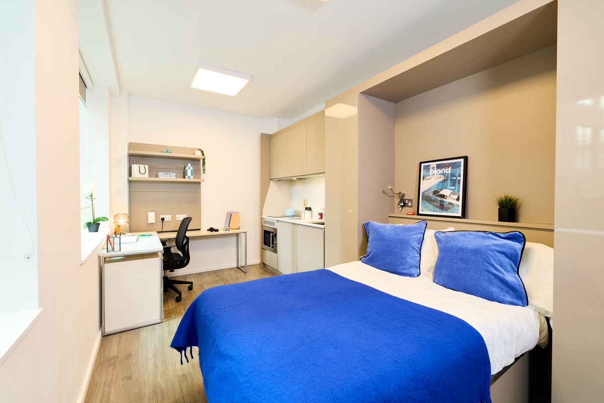 Bed desk kitchenette and shelves studio apartment at Vita Student Zed Alley in Bristol Student Accommodation