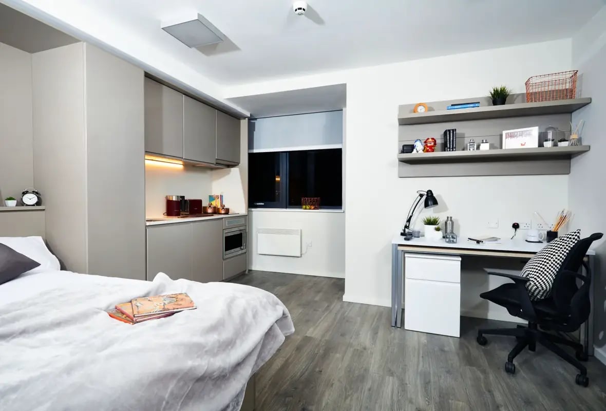 Bed desk kitchen cabinets and shelves studio apartment at Vita Student Richmond House in Southampton Student Accommodation