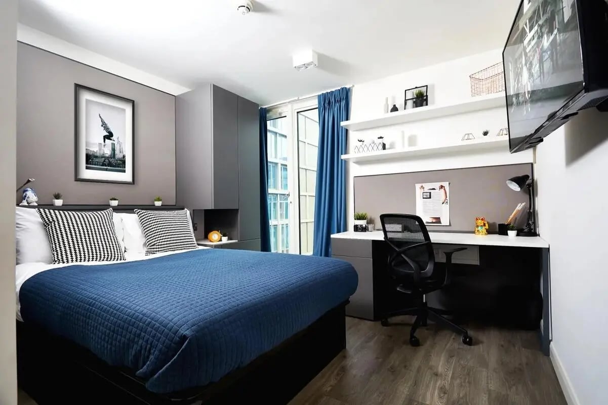 Blue bed black and white pillows artwork desk bedroom at Vita Student Newcastle Strawberry Place in Newcastle Upon Tyne Student Accommodation