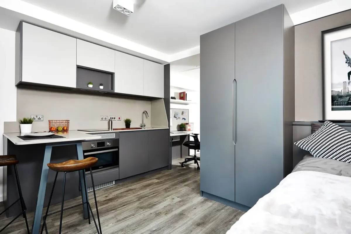 Kitchen area with bar stools and wardrobe living area at Vita Student Fountainbridge - Edinburgh in Edinburgh Student Accommodation