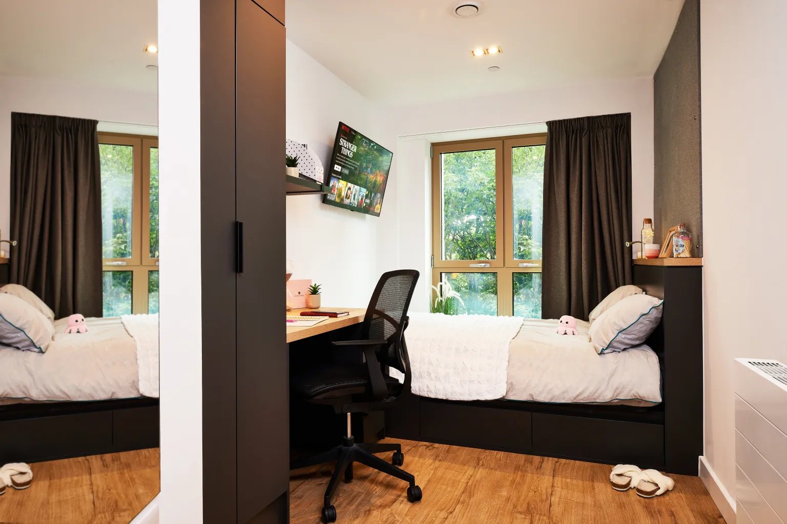 Bed desk chair TV and wardrobe student bedroom at Vita Student Lewisham Exchange in London Student Accommodation