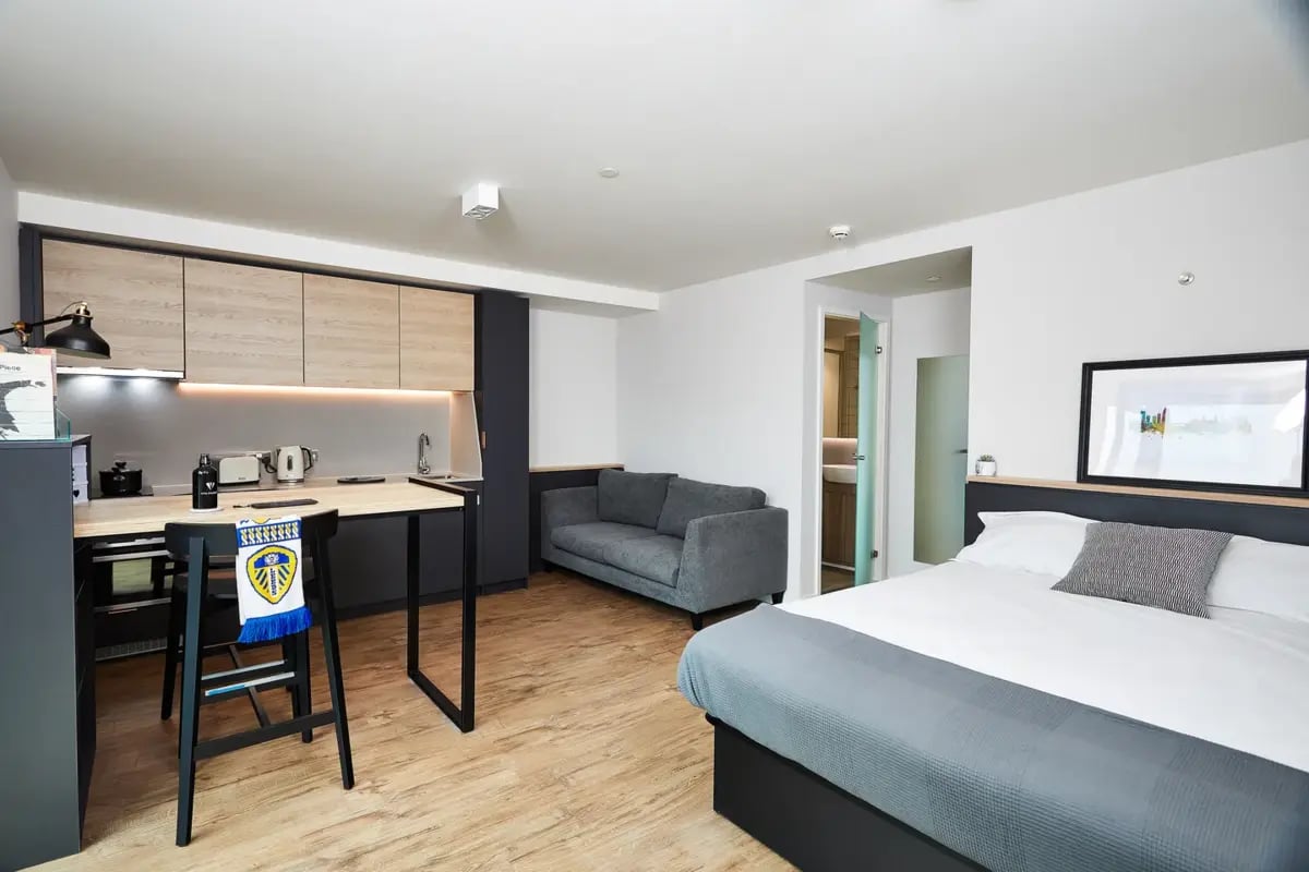 Bed sofa kitchenette and dining table studio apartment at Vita Student St.Albans in Leeds Student Accommodation
