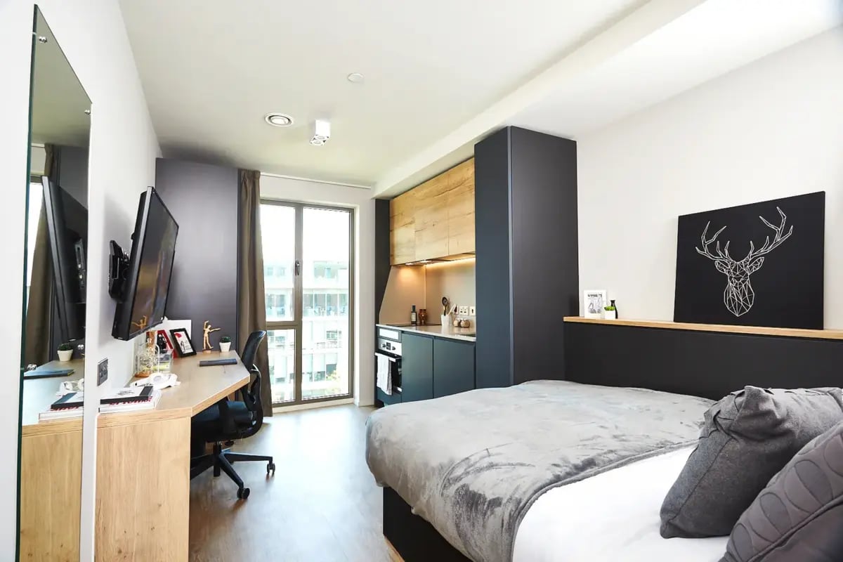 Desk bed kitchen area with stag art living room at Vita Student Station Street in Nottingham Student Accommodation
