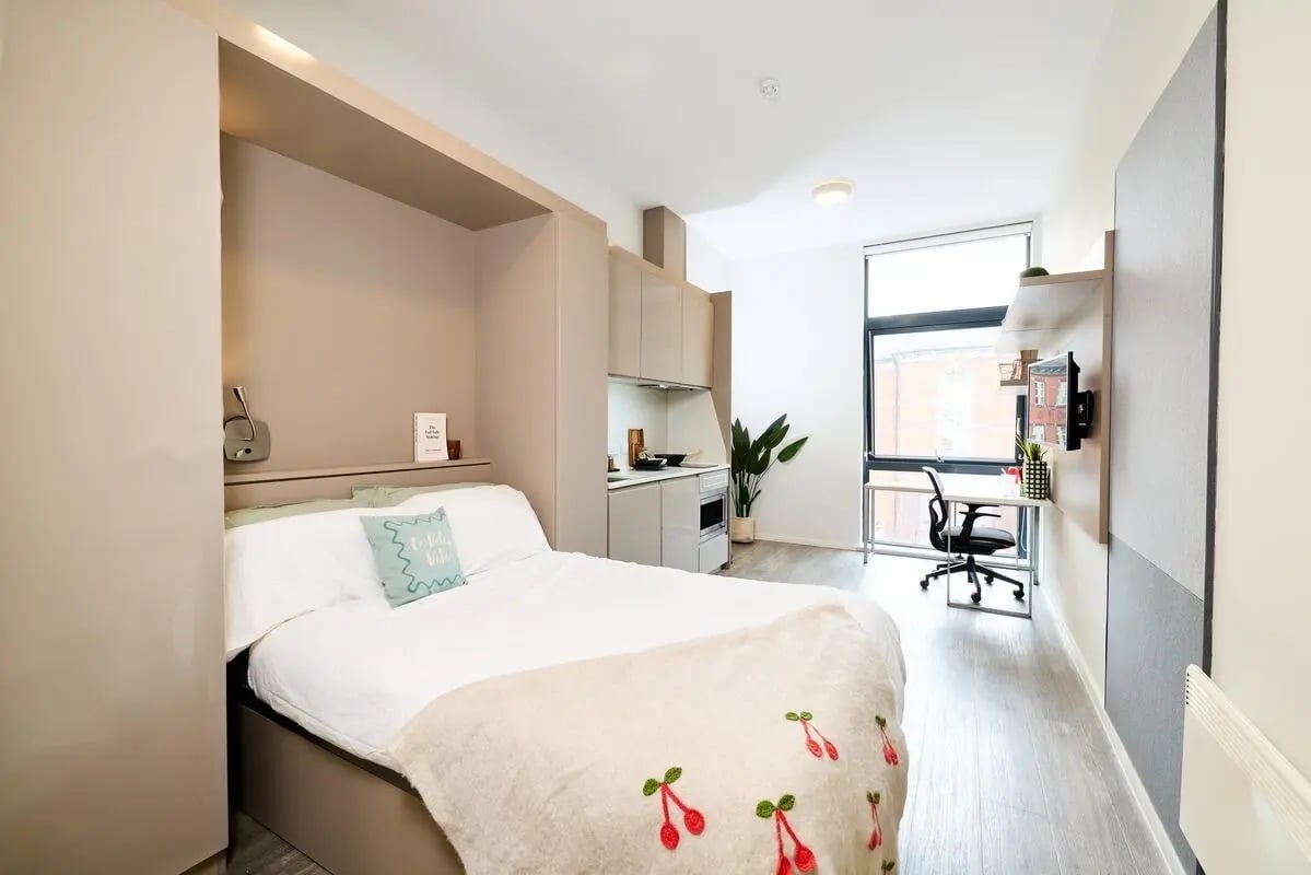 Bed desk kitchen with appliances and window studio apartment at Vita Student Portland House - Exeter in Exeter Student Accommodation
