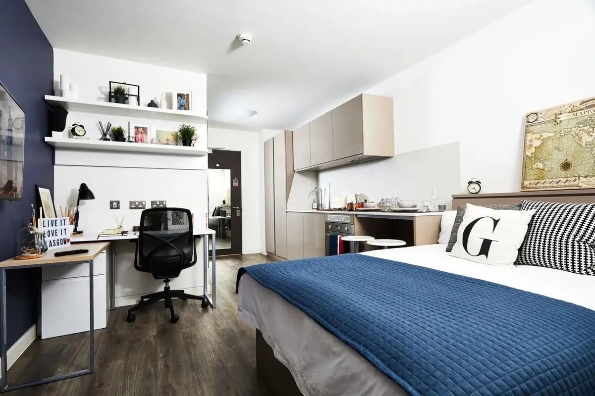 Bed desk kitchen and wall shelves studio apartment at Vita Student West End - Glasgow in Glasgow Student Accommodation